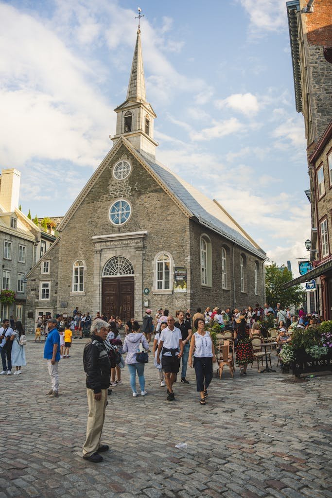 People near Notre-Dame-des-Victoires Catholic Church in Quebec in Canada