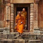 Two Monk in Orange Robe Walking Down the Concrete Stairs
